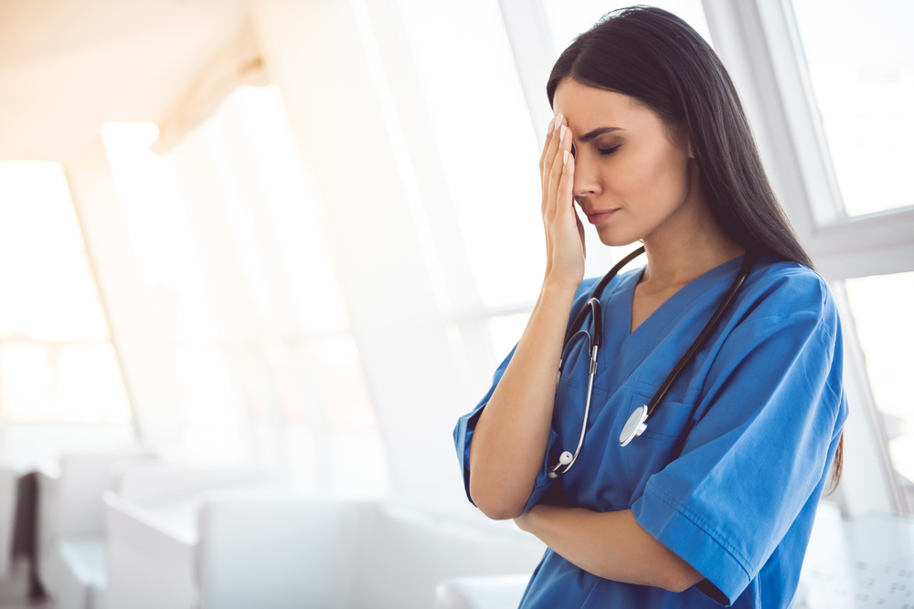 Beautiful,Doctor,In,Blue,Scrubs,Is,Covering,Her,Face,While