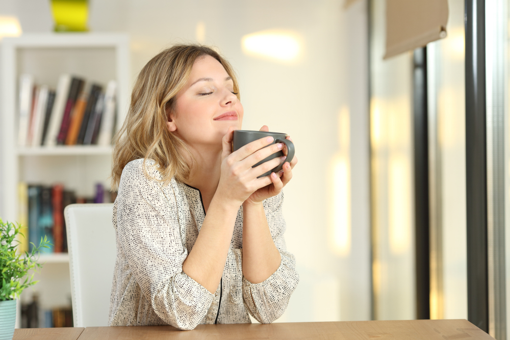 Portrait,Of,A,Woman,Breathing,And,Holding,A,Coffee,Mug
