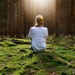 Younf,Female,Sitting,Alone,In,Green,Forest,Enjoys,The,Silence