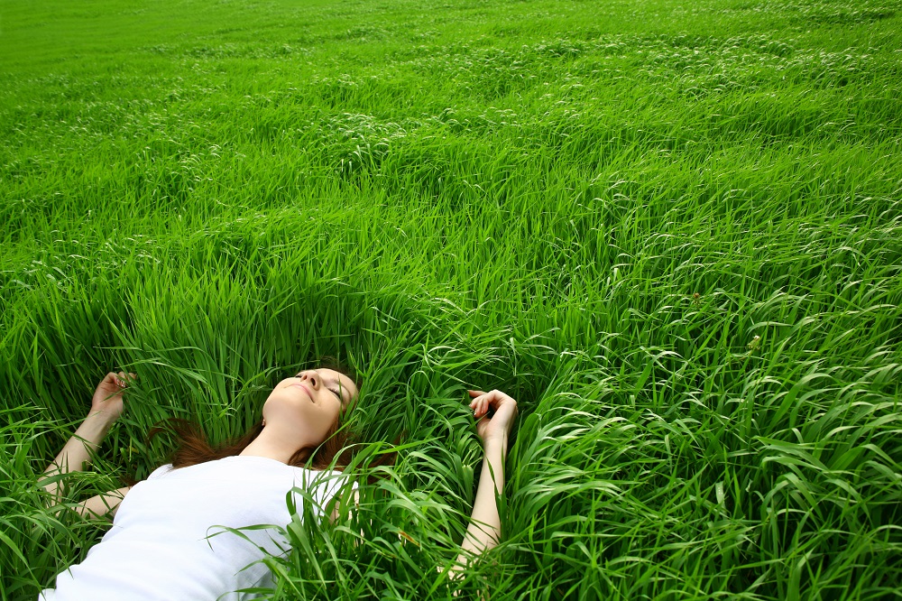 beautiful girl lying down of grass