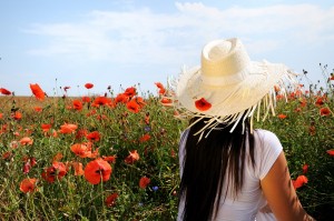 Young beautiful woman in poppy flowers