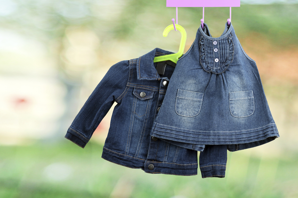 Fashion baby  denim dress with  jacket  hanging on a hanger