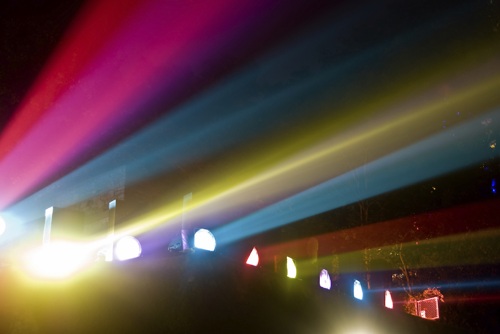 multi-colored spotlights create streaks at night