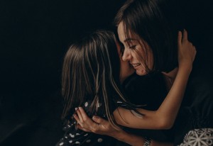 Loving,Mother,And,Daughter,Gently,Hug,Each,Other,,They,Smile