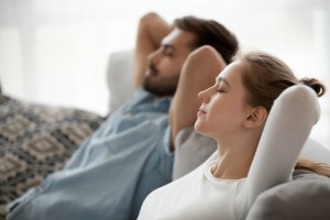 Relaxed,Couple,Resting,On,Comfortable,Couch,,Happy,Calm,Man,And