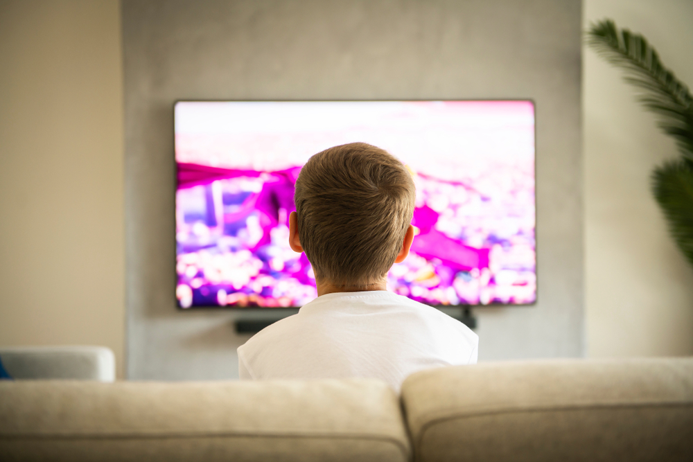 Back,View,Image,Of,Cute,Boy,Sitting,On,Sofa,And