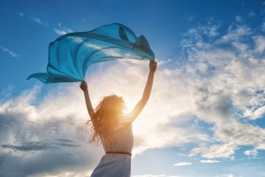 Beautiful,Young,Woman,On,Sunset,Background,With,Blue,Tissue.