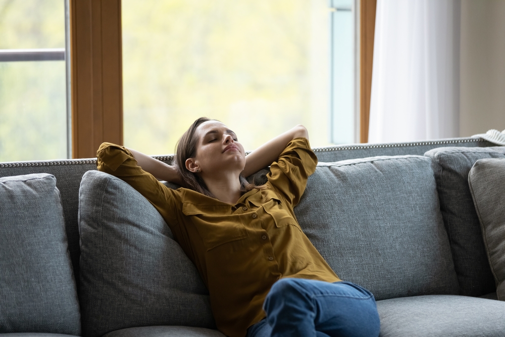 Calm,Serene,Sleepy,Young,Woman,Relaxing,On,Comfortable,Sofa,At